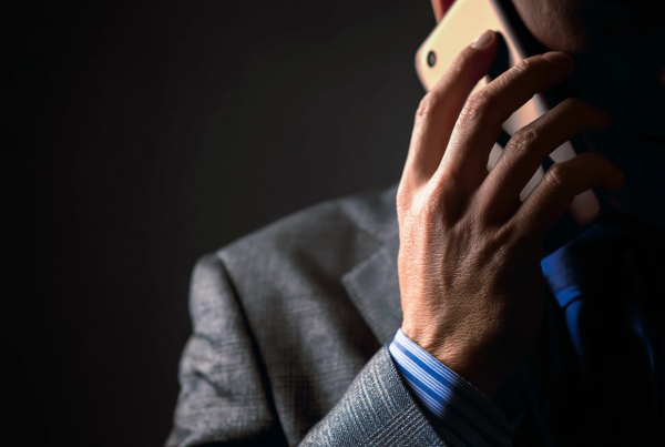 man holding phone in fear